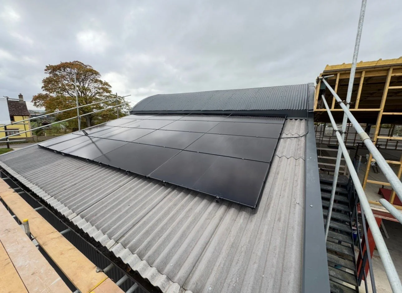 Solar panels mounted along a commercial metal roof